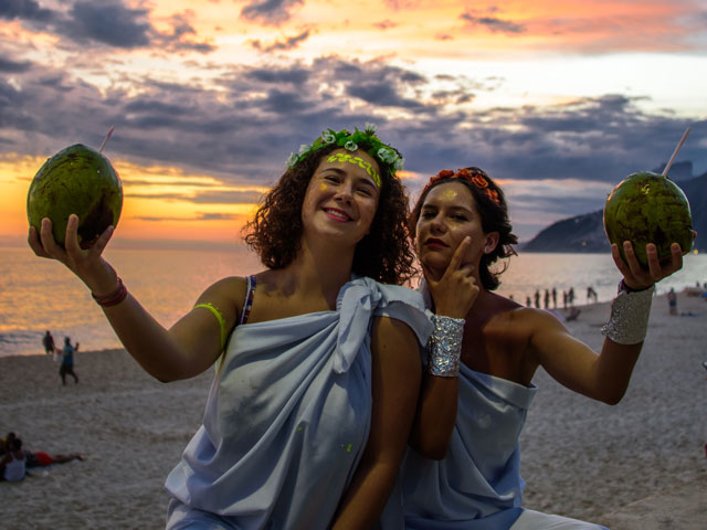 Two roman women enjoying a Toga Party on a beach