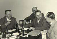 Old photo of a meeting of agricultural machinery dealers at a tavern.