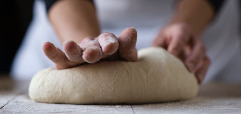 pressing dough by hand