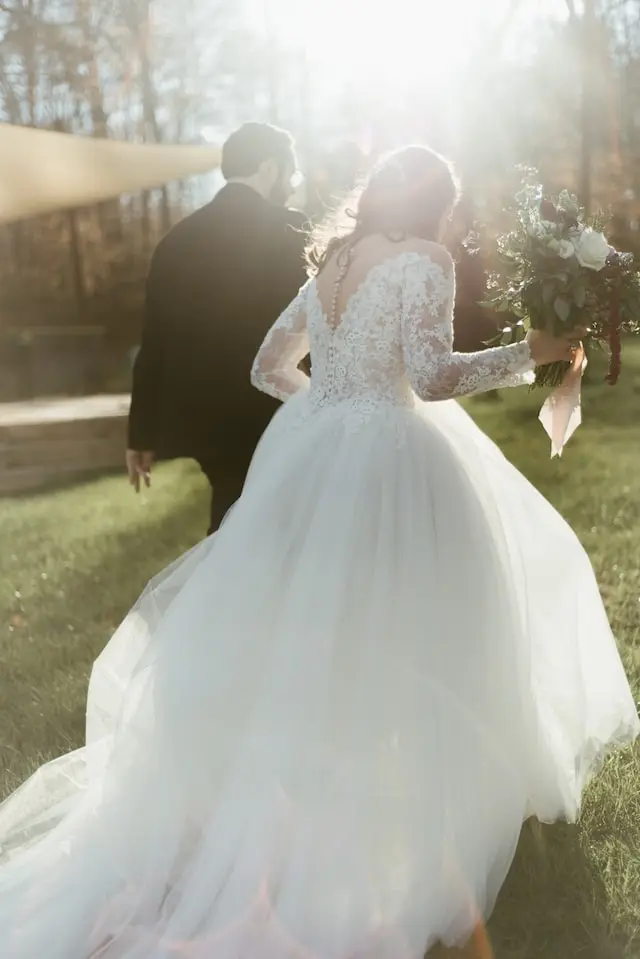 A couple at their wedding walking with their backs to the camera