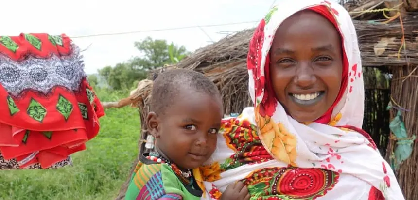 Ache, a mother of two in Chad, holds her baby son