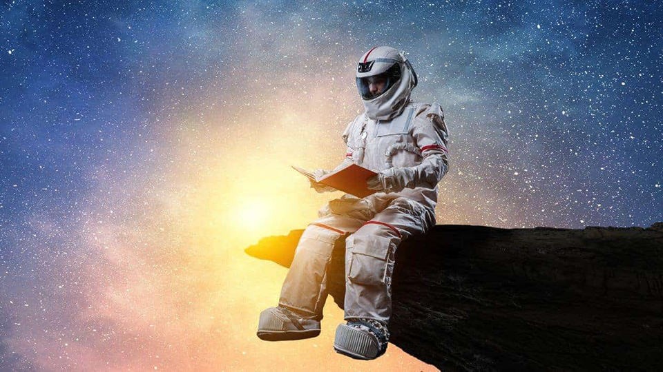 astronaut reading a book 