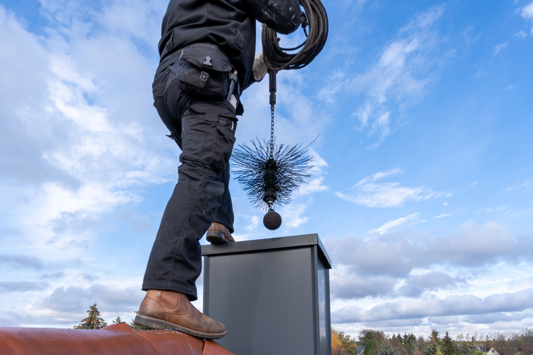 man cleaning chimney