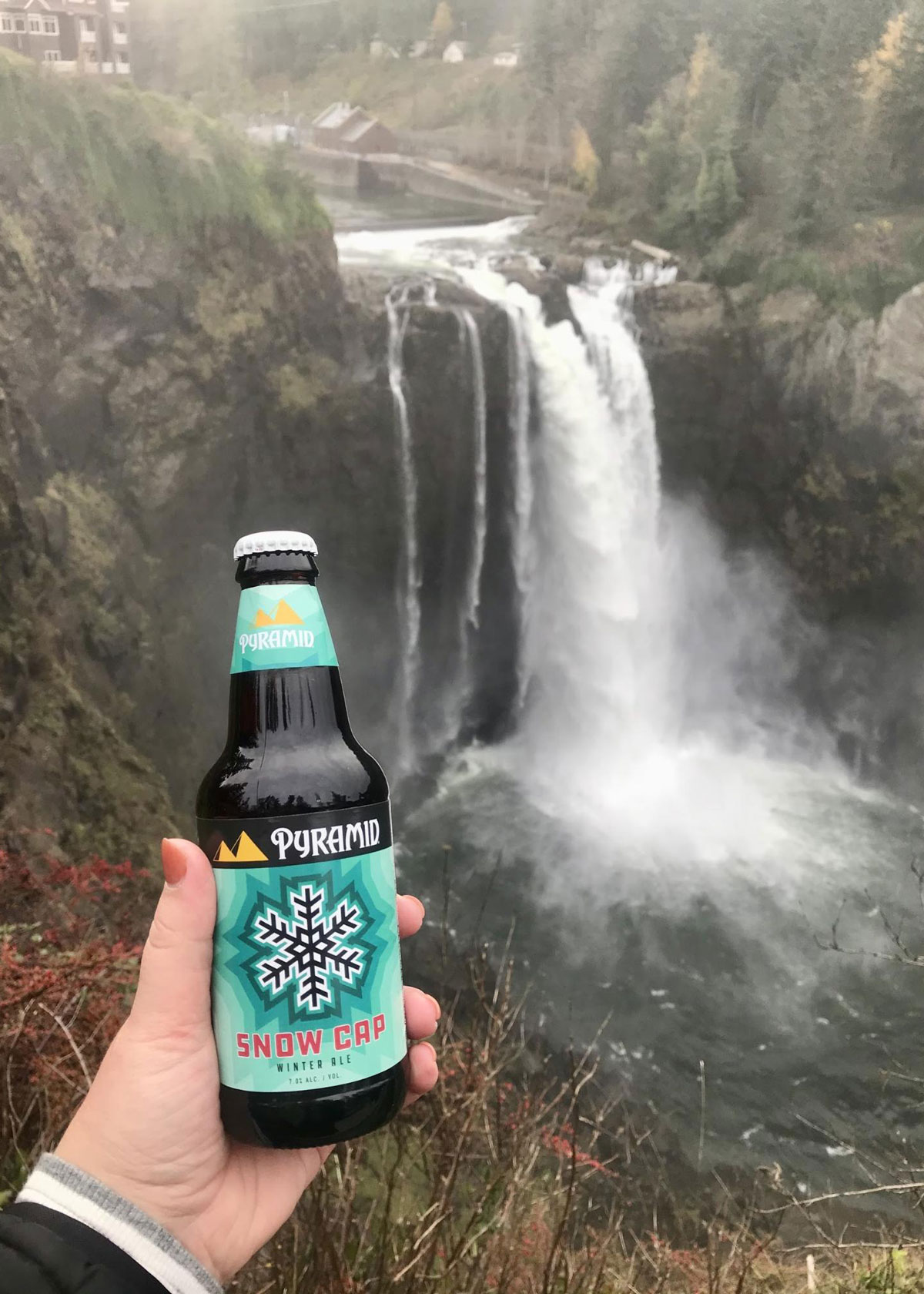 Snoqualimie Falls in the background, and a bottle of Pyramid Snow Cap Ale in the foreground