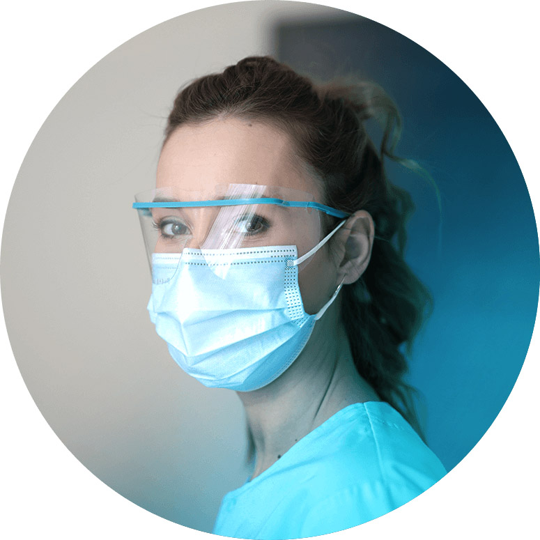Woman wearing scrubs and a mask
