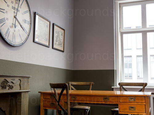 Traditional private office featuring classic wooden desk and chairs next to large analogue wall clock Zoom background