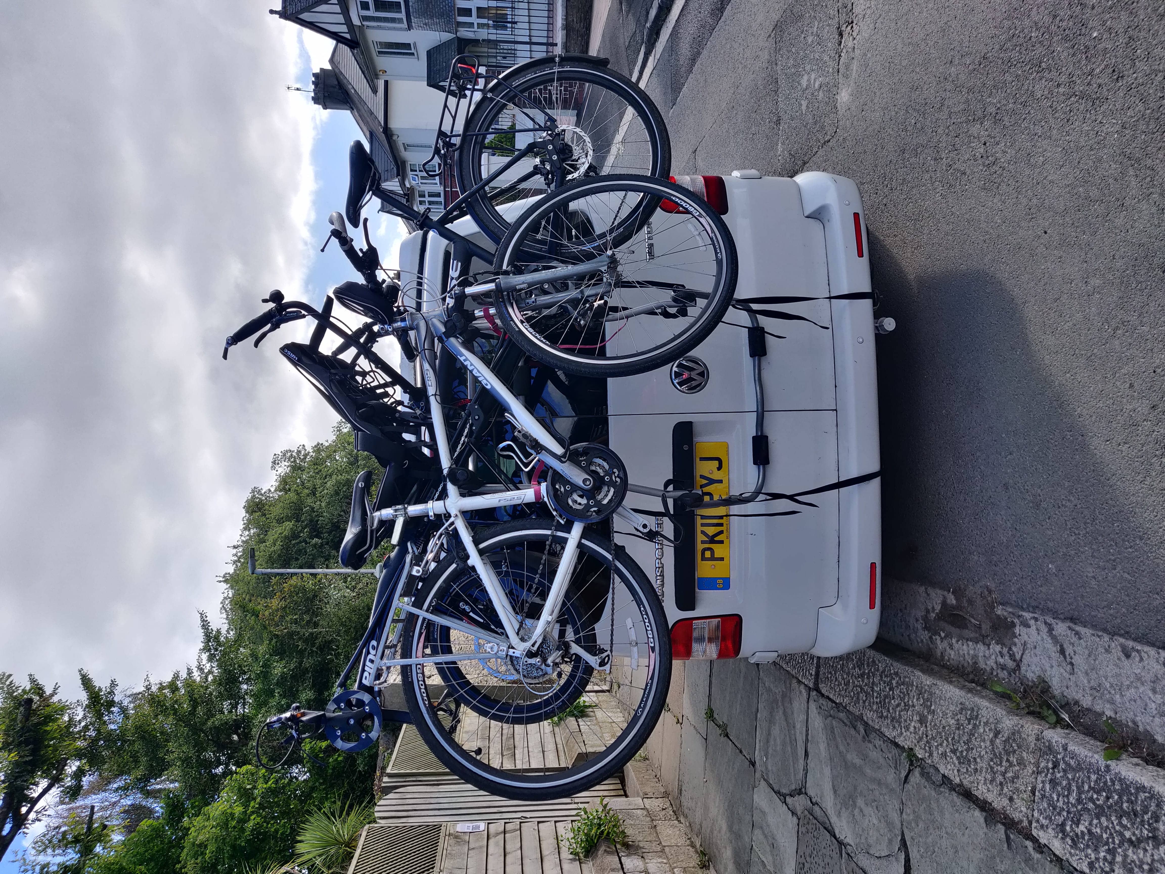 The Pino and Hannah&rsquo;s bike loaded on the back of the van, it does overhang quite a lot!