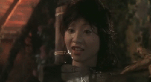 An animated gif of a scene from the Japanese film 'House' showing the severed head of a girl throwing up red water.