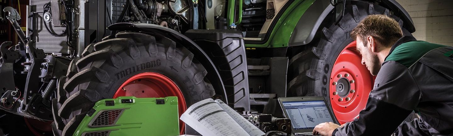 Image of a technician working on a tractor
