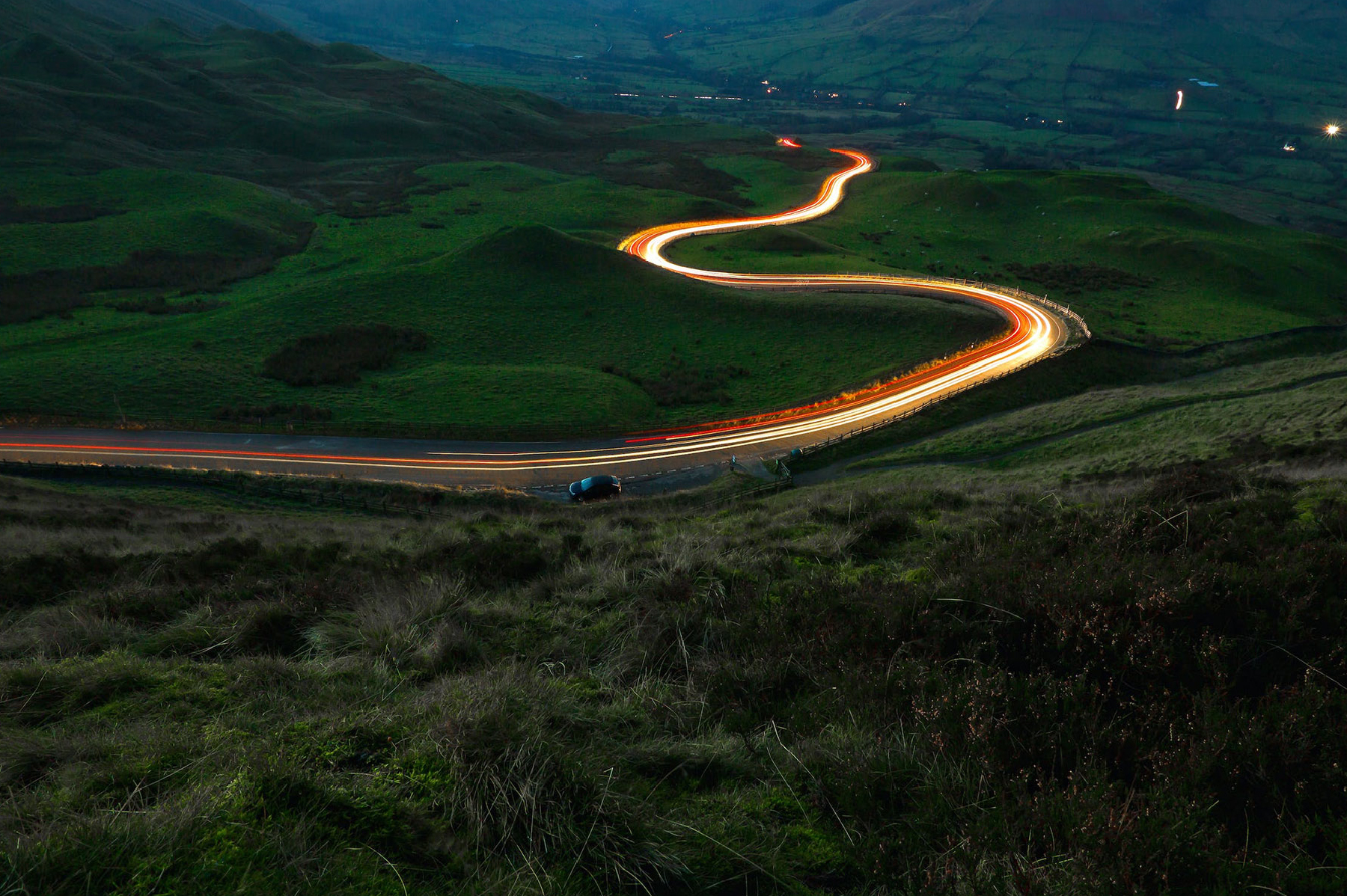 road winding through a countryside at night