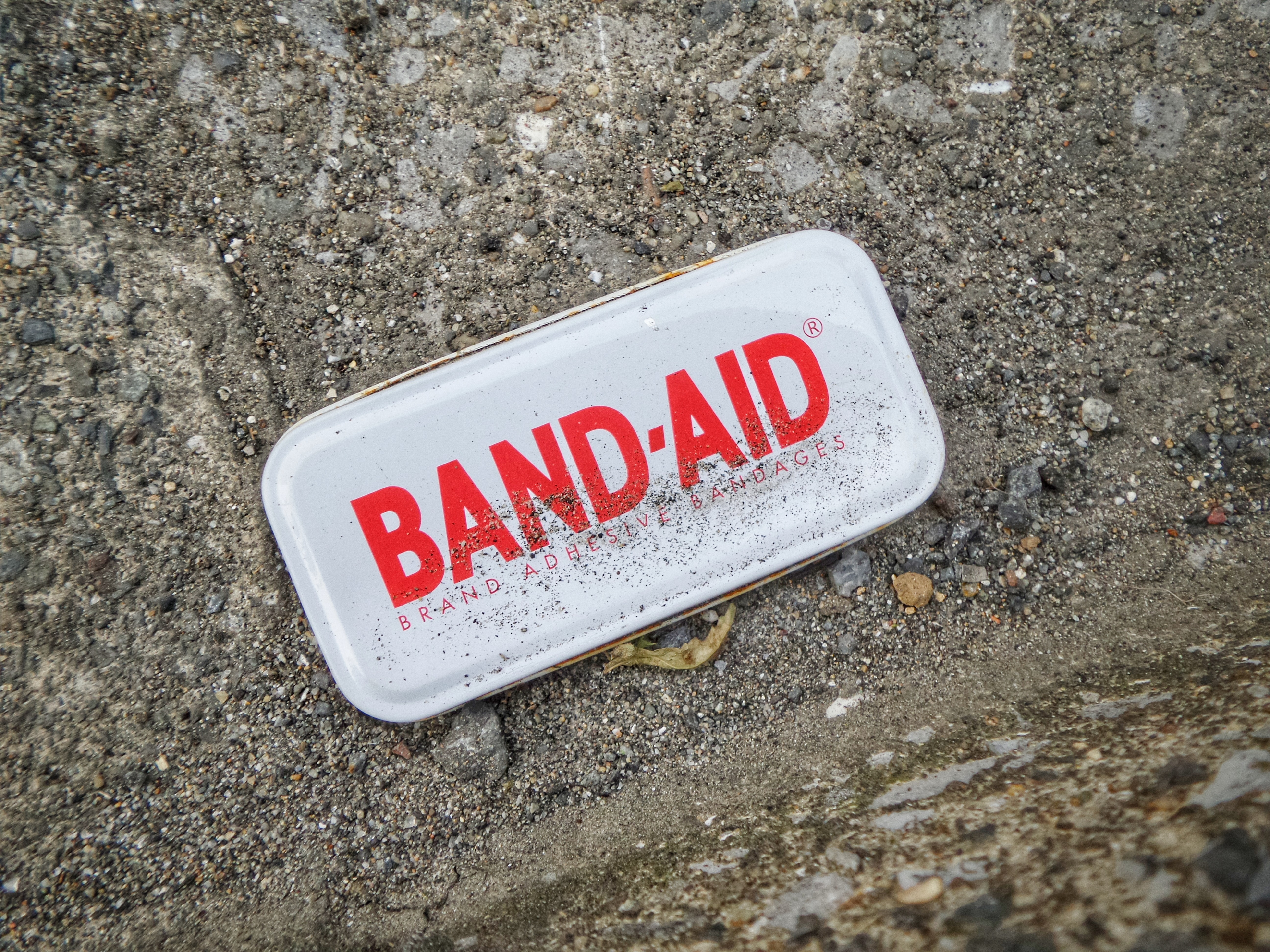 A Band-Aid package on the pavement.