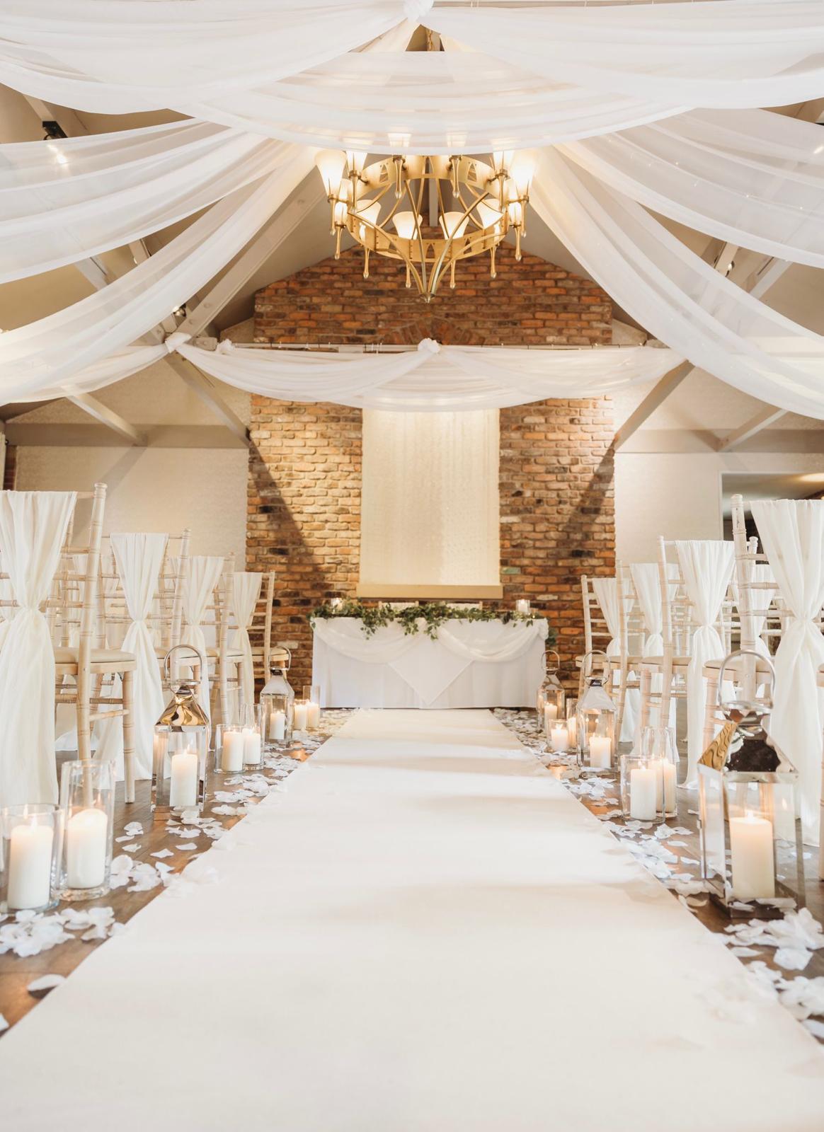 gorgeous wedding ceremony aisle in white rustic marquee setting