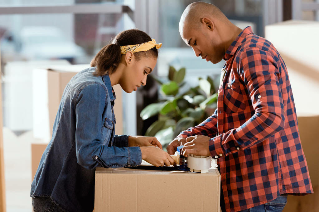 couple packing cardboard for home moving