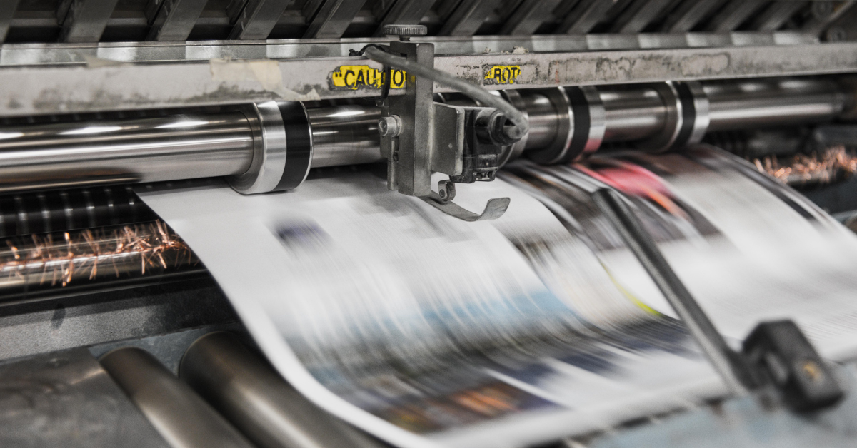 Newspaper being printed on a printing press