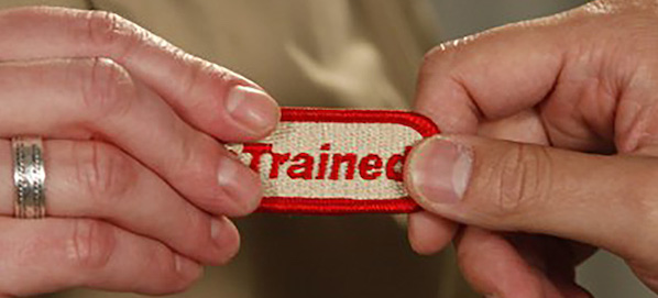 Photo of a trained patch being handed to another person