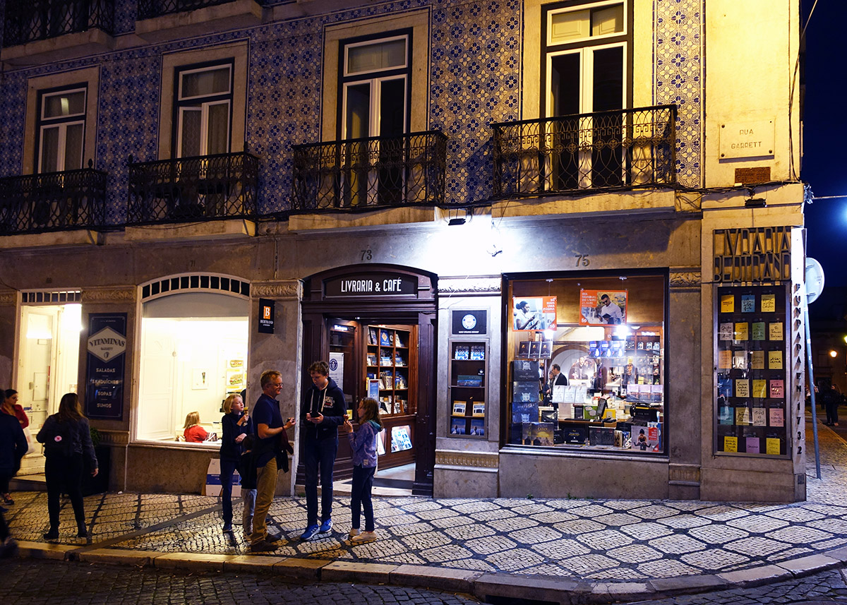 front facade of the bertrand bookshop with white and blue tiles at night