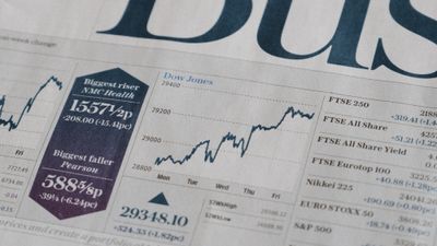 News paper showing Dow Jones Index up.