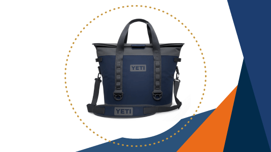 A navy blue YETI soft-sided cooler with a shoulder strap