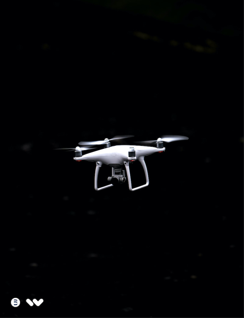 A display of a white drone flying with a black background, with the Wunder and Bernstein logo's featured.