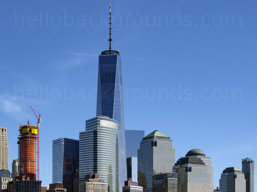 Urban cityscape at mid-day featuring many office buildings with one tall prominent building with top mast in centre Microsoft Teams background