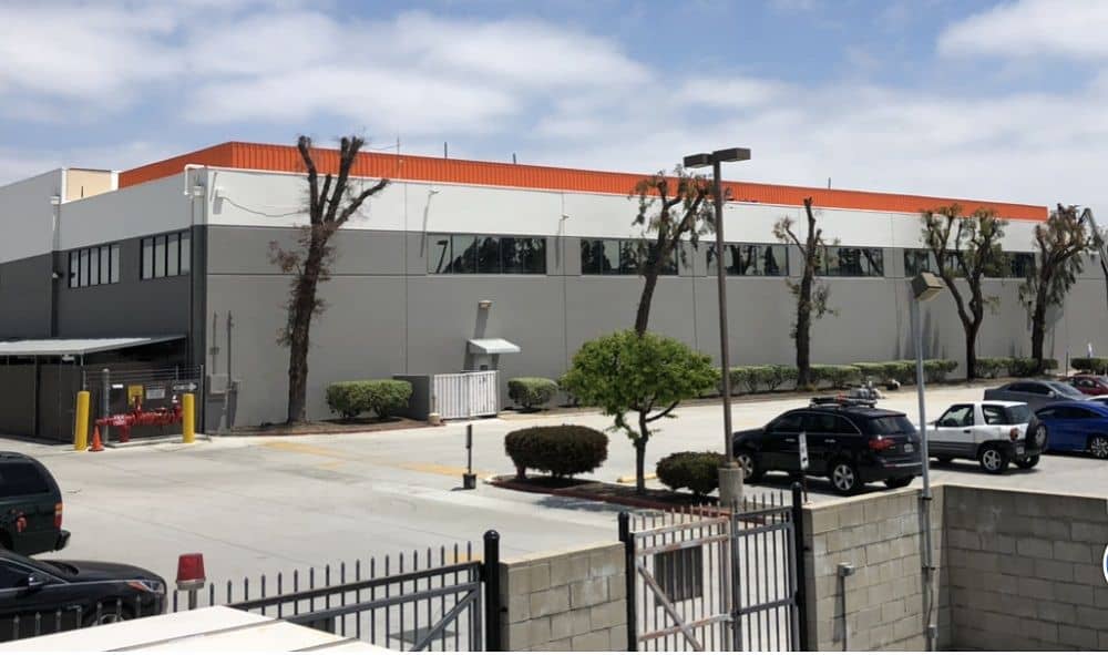 enlarged photo of newly painted large industrial building with dark grey exterior walls