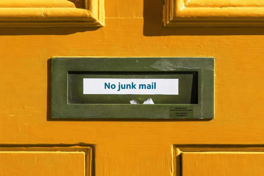 Mail slot on a door with the label "No junk mail"