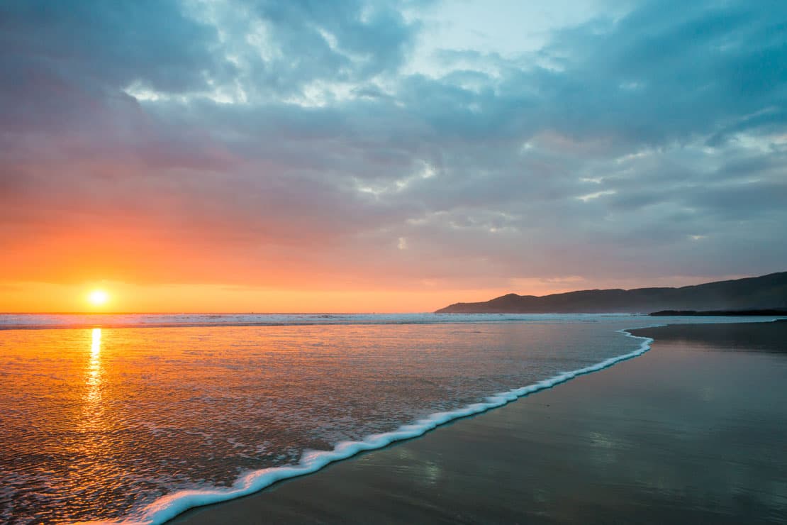 a sandy beach at sunset