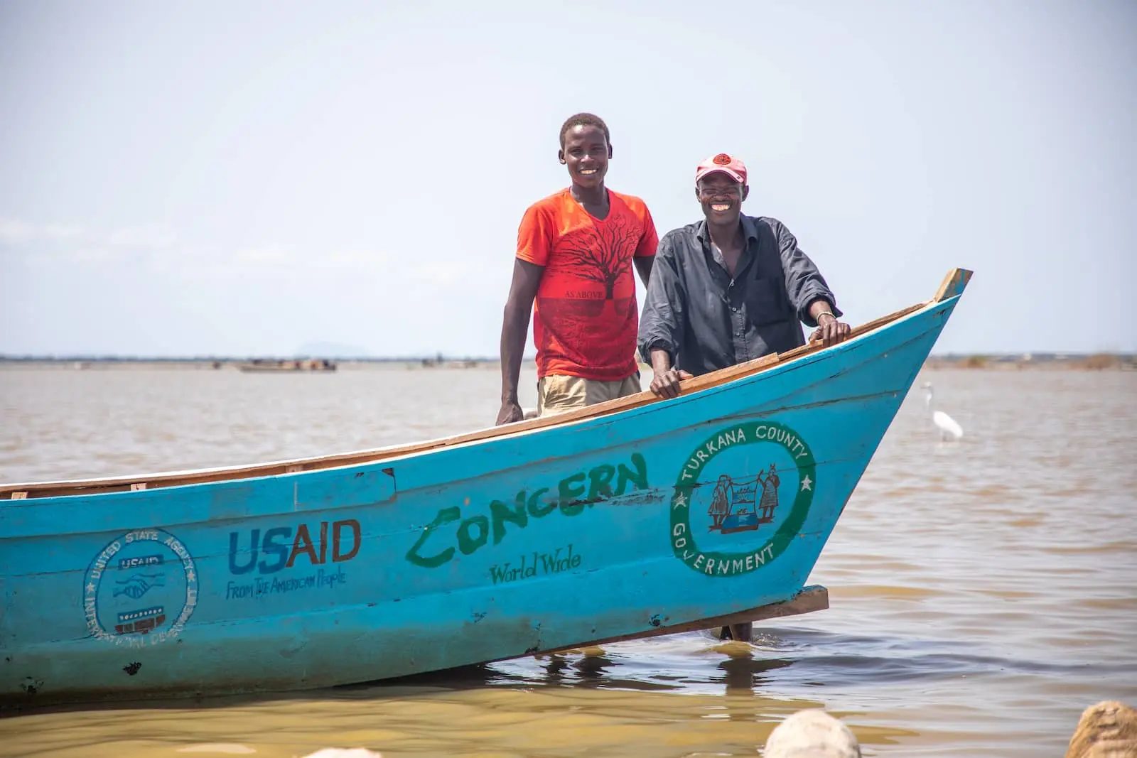Local fishermen in Kenya with a new fishing boat donated by Concern as part of a disaster risk reduction program funded by US foreign aid.