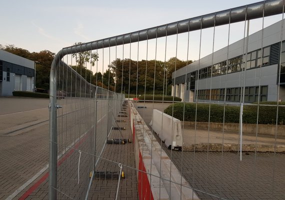 a long row of concrete blocks and fencing in front