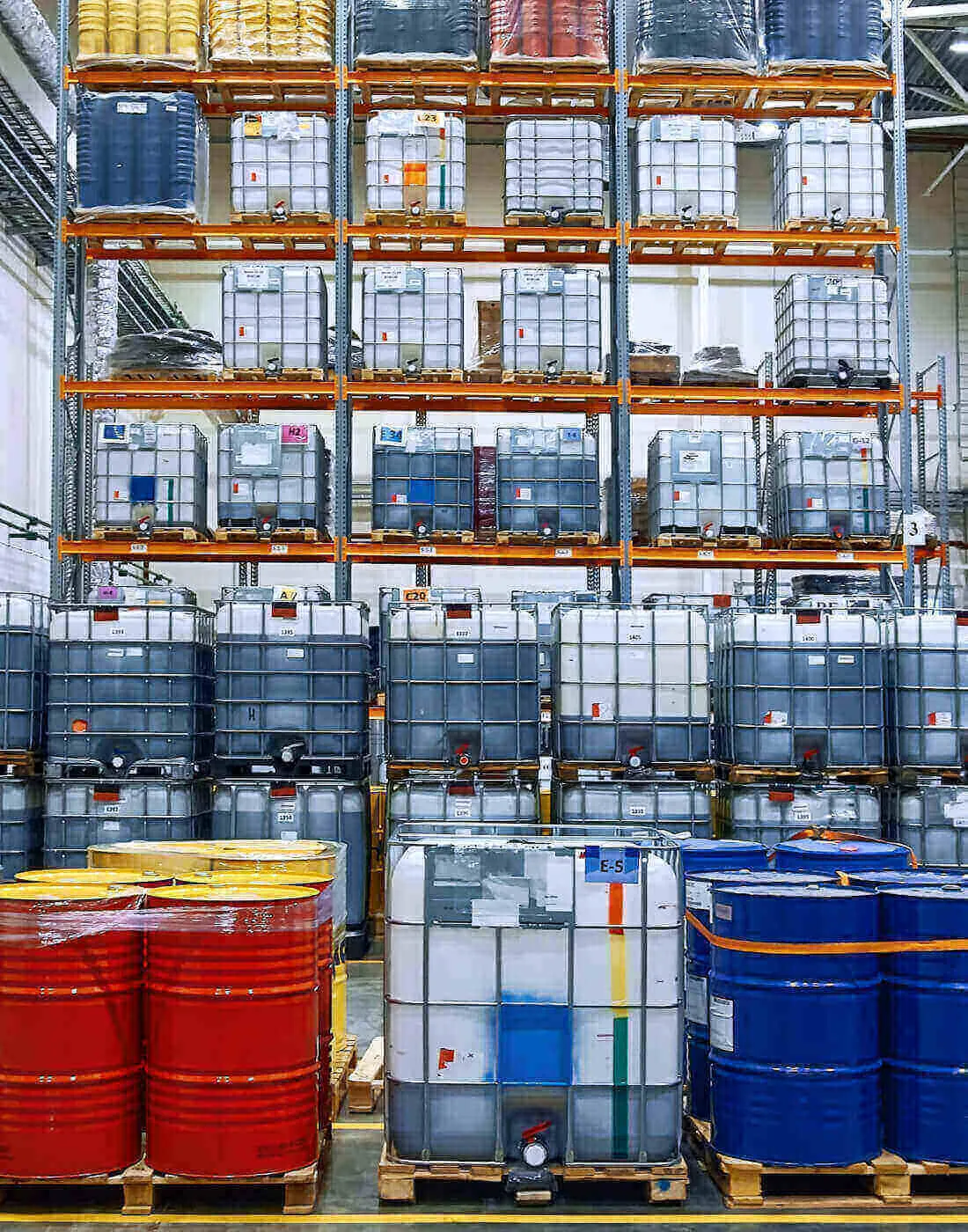 neatly stacked and packaged containers lined up on tall shelves in a warehouse