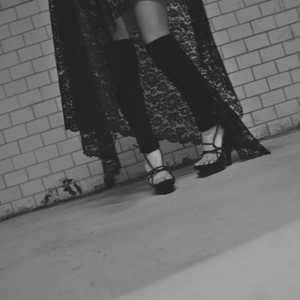 Hot woman in hight heels. Avant garde fashion. Haute de couture. Tribal postapocaliptic fashion. Foot fetish