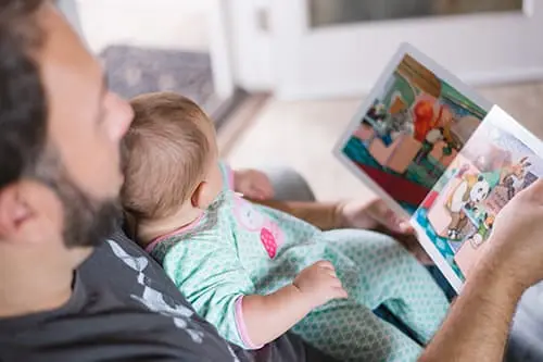 A man reading to his child