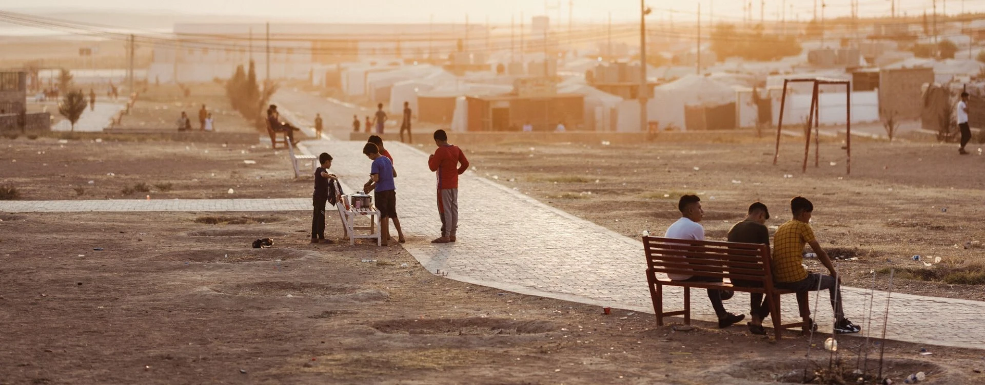 People outside at dusk in Iraq.