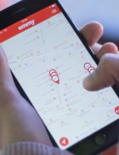 Phone with opened Wunder app that is custom branded for emmy company.