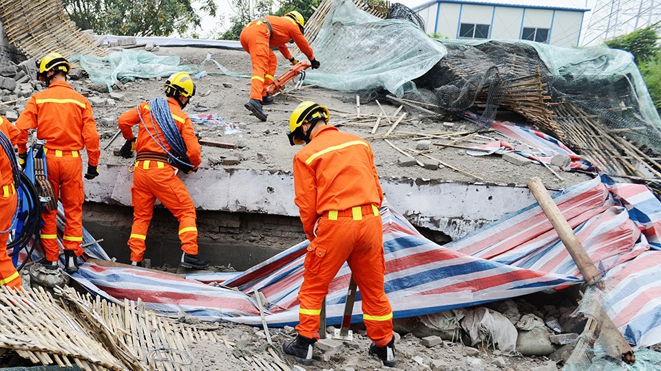 Emergency response leaders showcasing disaster resilience as they clear up a disaster site.