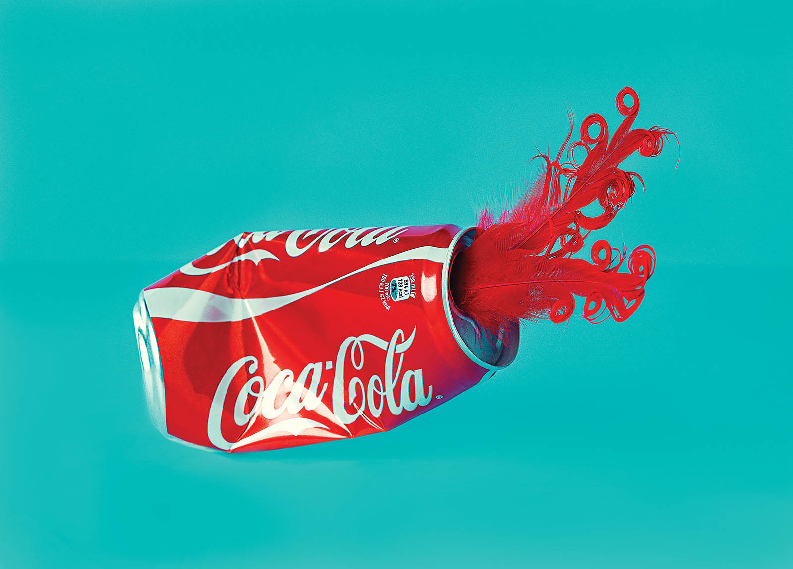 Coca-Cola can with red feathers coming out