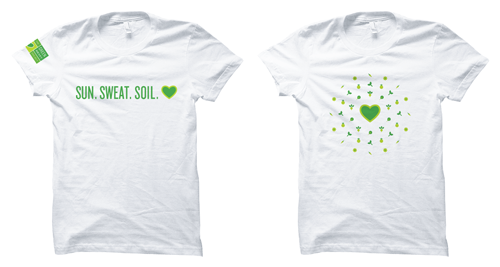Two t-shirts, one that says Sun, sweat, soil, the other has an abstract pattern made of vegetable illustrations