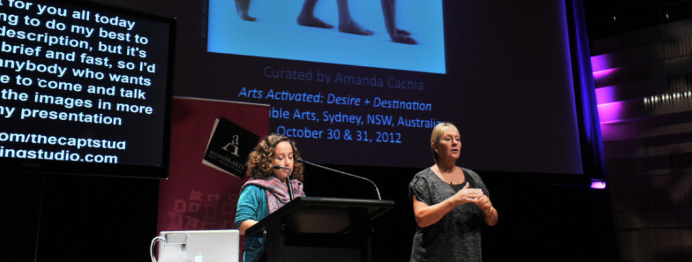 Amanda Cachia giving a lecture at a conference, at a traditional lectern.
