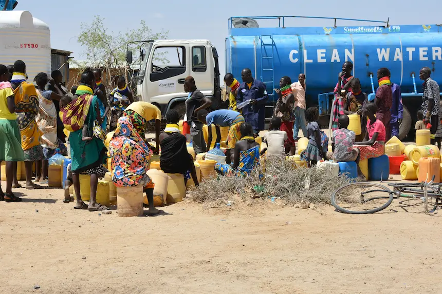 People gather at a water truck in Kenya