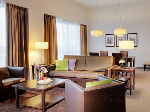 Minimal living room featuring brown leather furniture and yellow lights Google Meet background