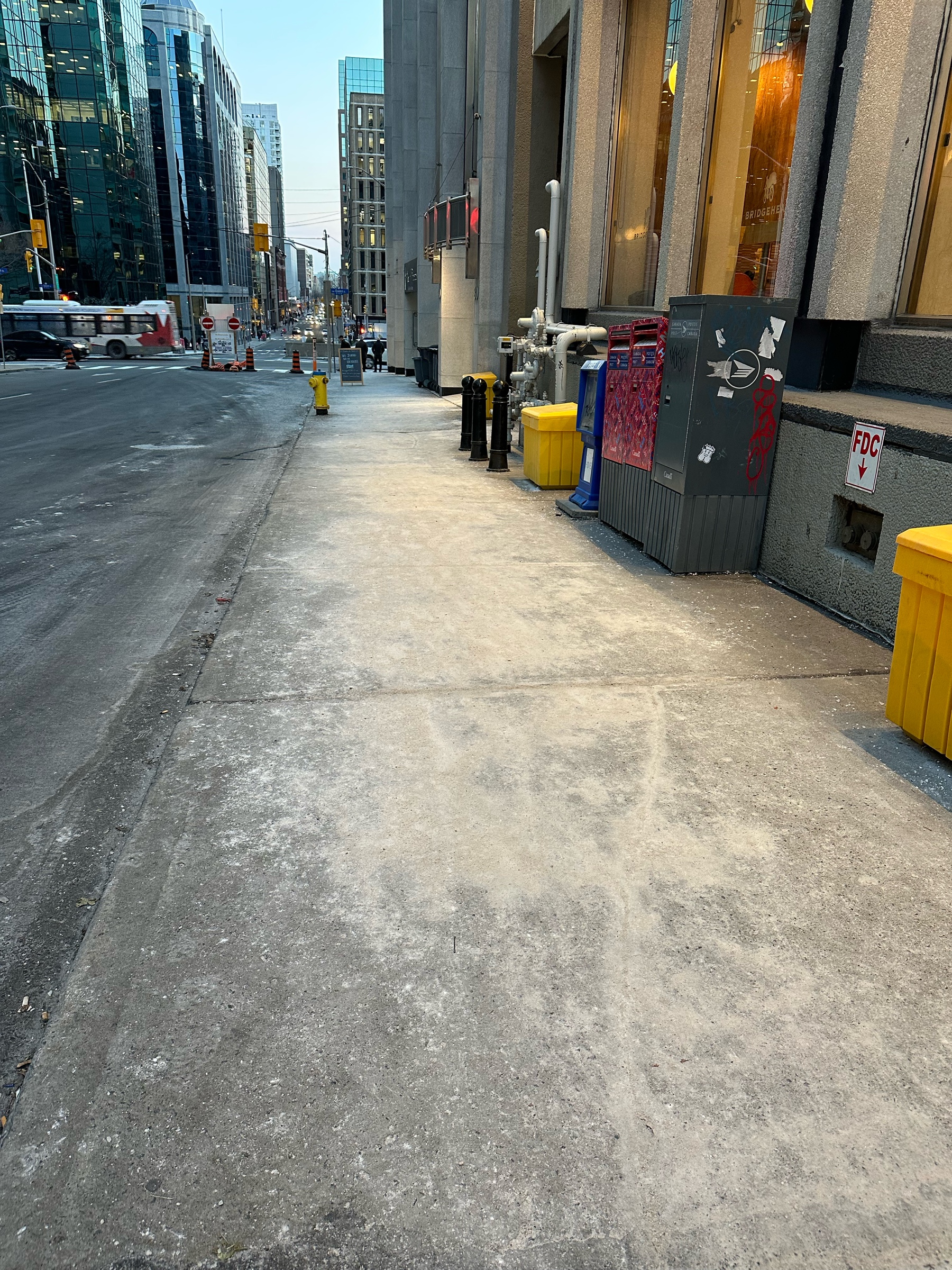 A grey sidewalk turned white with salt.