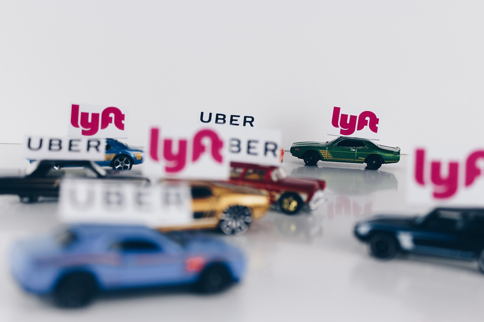 A colorful toy car with Lyft and Uber signs on.