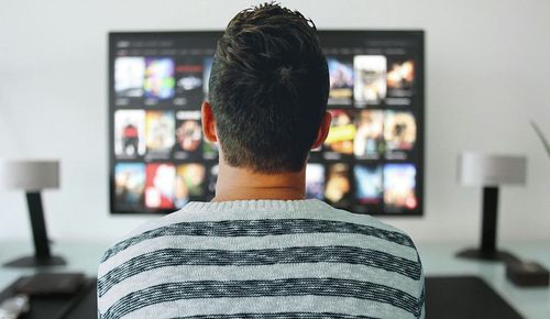 a person siting in front of TV screen