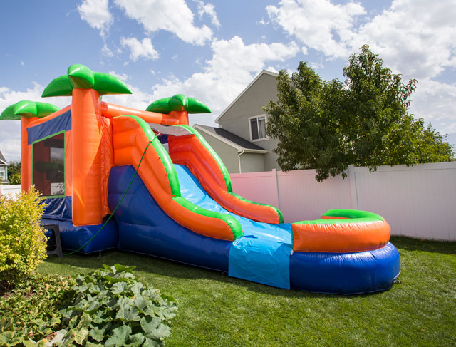 A very large inflatable bounce house with a water slide