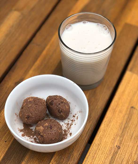 Chocolate casein balls and a glass of milk