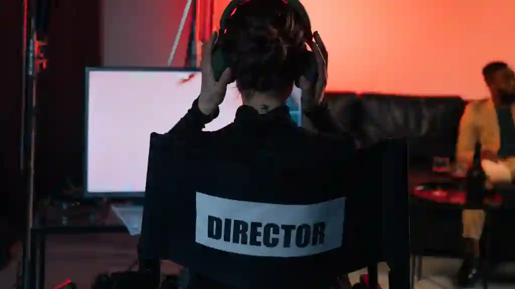  Hero Image: Person sitting in director's chair, from behind, wearing headphones 