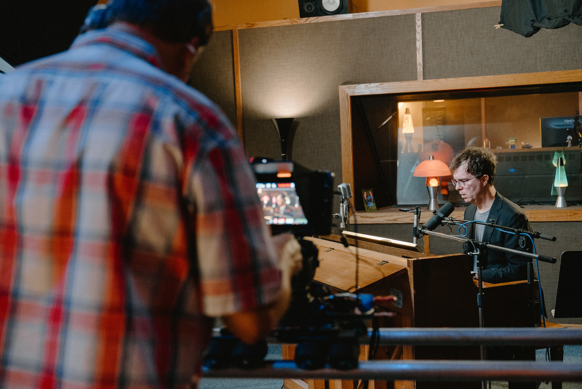Production team filming Ben Folds playing piano.