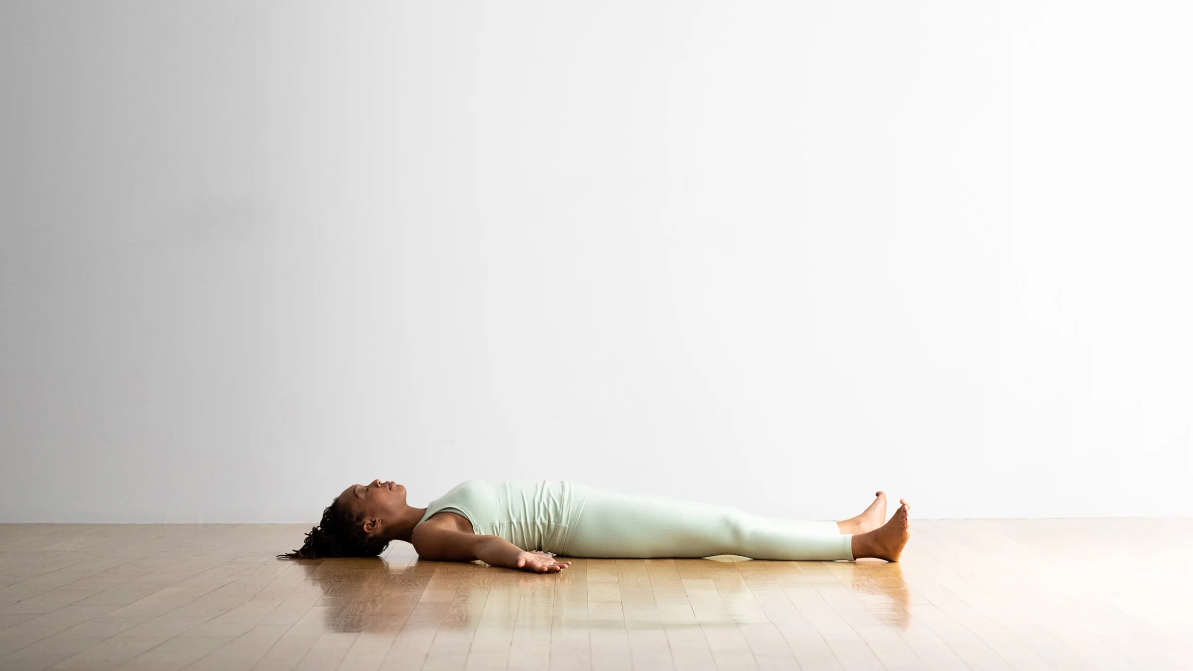 Woman doing yoga corpse pose