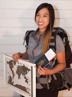 Jade Huynh with a map and travel gear.