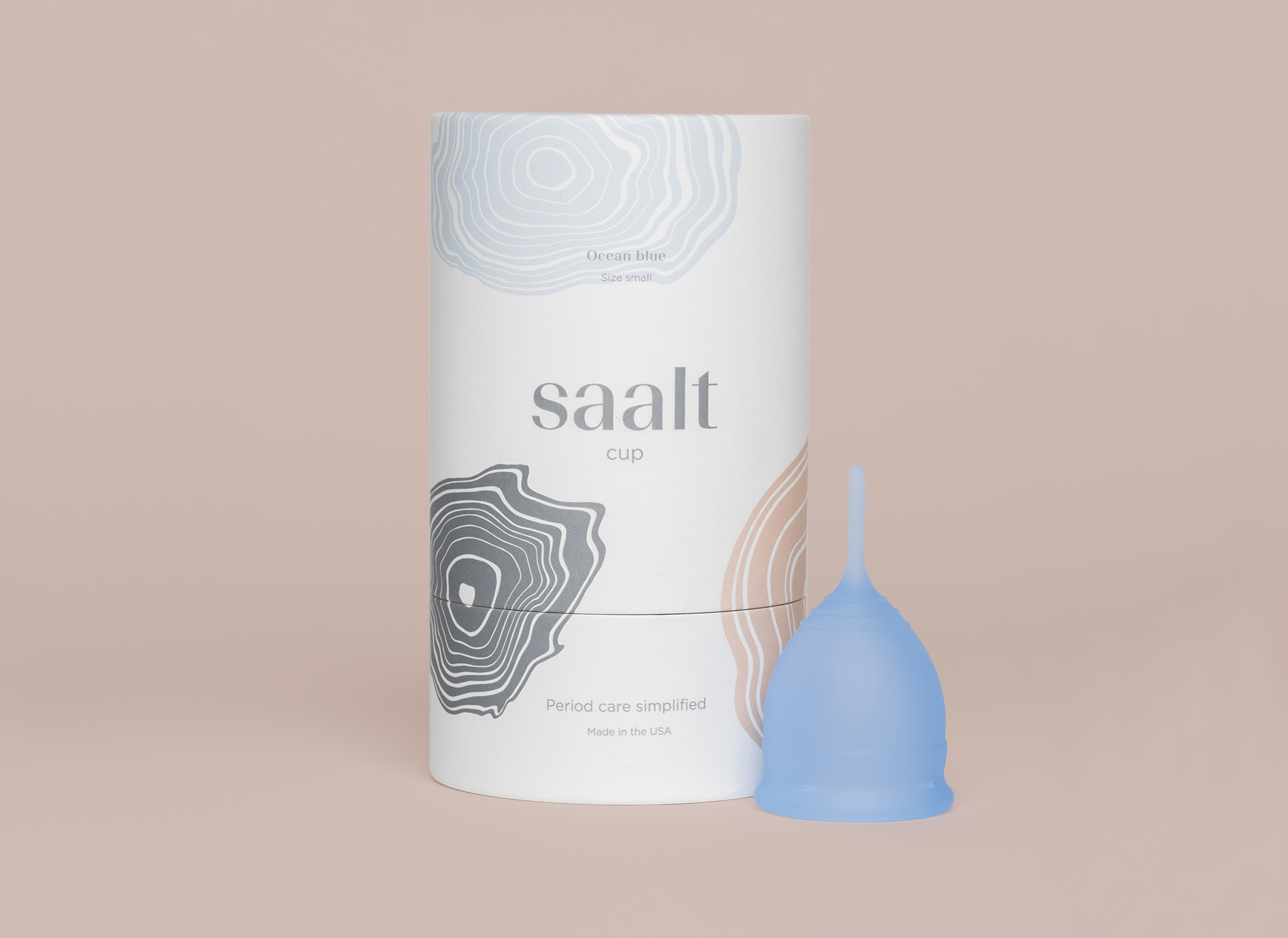 Blue menstrual cup next to tube packaging